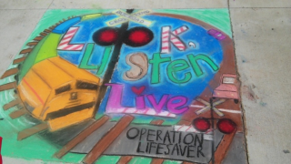 an image of a chalk drawing depicting rail safety messages