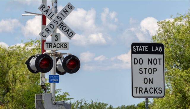 grade crossing signal and do not stop on tracks sign