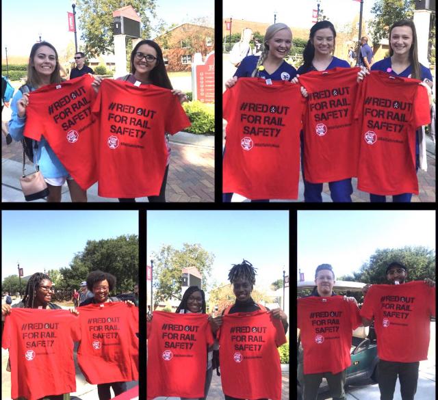people holding up rail safety week red out for rail safety t-shirts