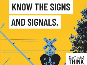 An image of railroad crossing signals with text