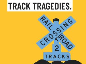A billboard showing a railroad crossing signal on a yellow background