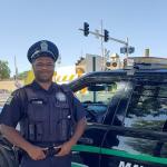 an officer standing next to a police car