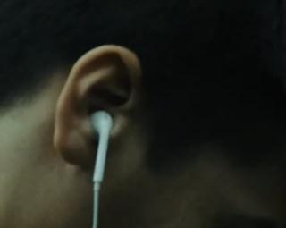 an image of a man's head wearing earbuds