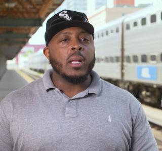 a man in a hat next to a train