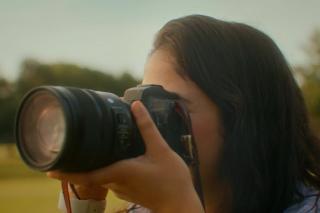 woman focusing a camera