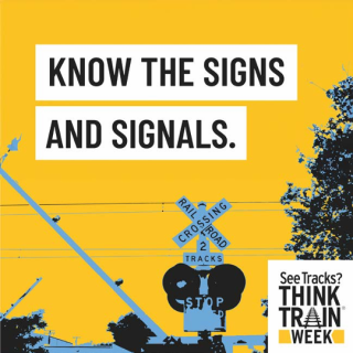 An image of railroad crossing signals with text