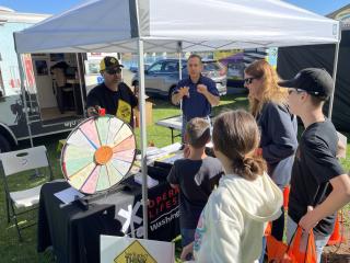 Volunteers at an outdoor event sharing a rail safety message with event attendees.