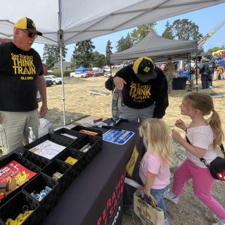 Volunteers teaching kids about rail safety.