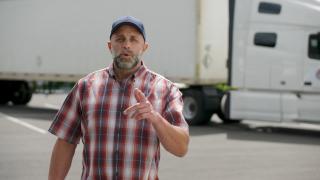 Trucker in front of his truck